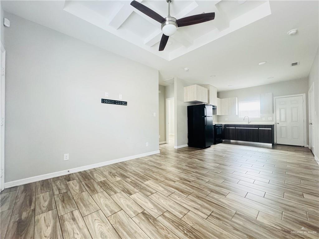 812 Kentucky Street, Unit 1 Mission, TX 78573 - Photo 7 of 18 wooden floor in an empty room with a kitchen