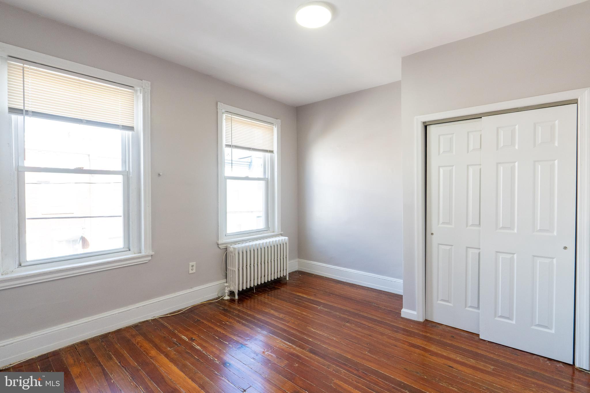 1826 McClellan Street Philadelphia, PA 19145 - Photo 11 of 22 an empty room with wooden floor and windows