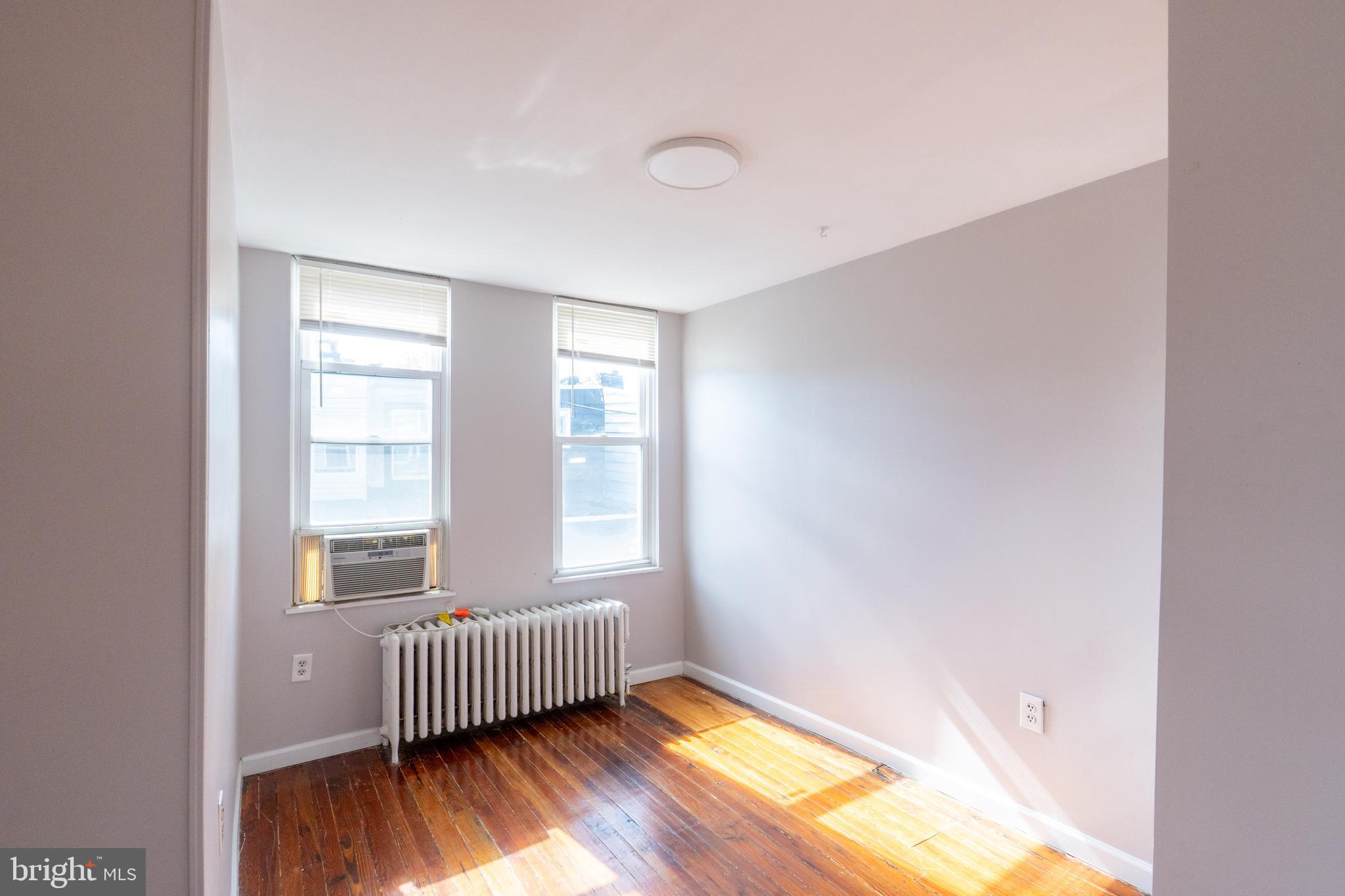 1826 McClellan Street Philadelphia, PA 19145 - Photo 16 of 22 a view of an empty room with wooden floor and a window