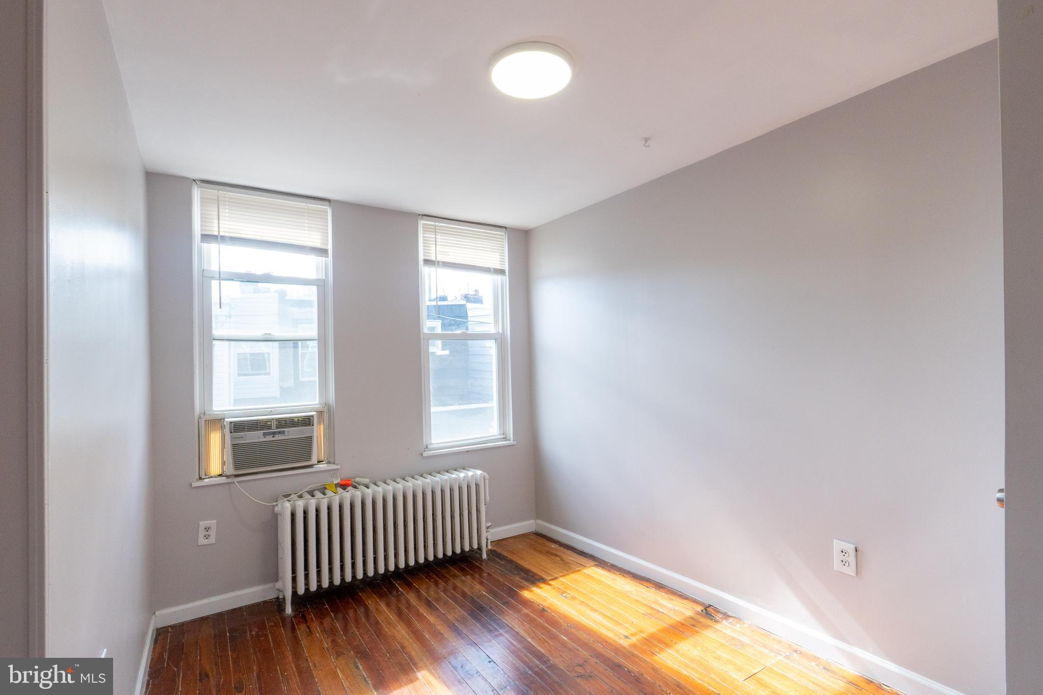 1826 McClellan Street Philadelphia, PA 19145 - Photo 19 of 22 a view of an empty room with wooden floor and a window