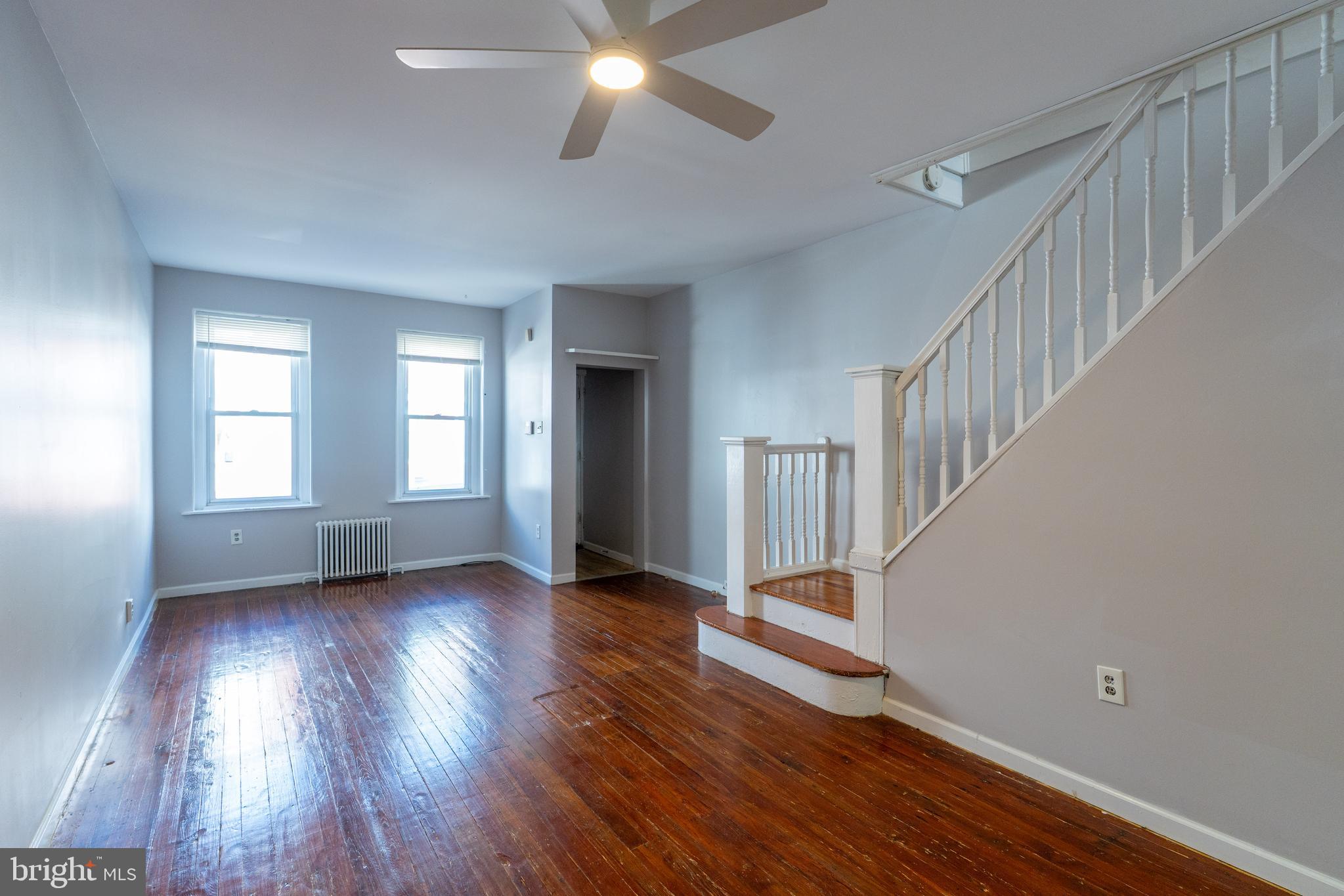 1826 McClellan Street Philadelphia, PA 19145 - Photo 4 of 22 a view of an empty room with wooden floor and fan