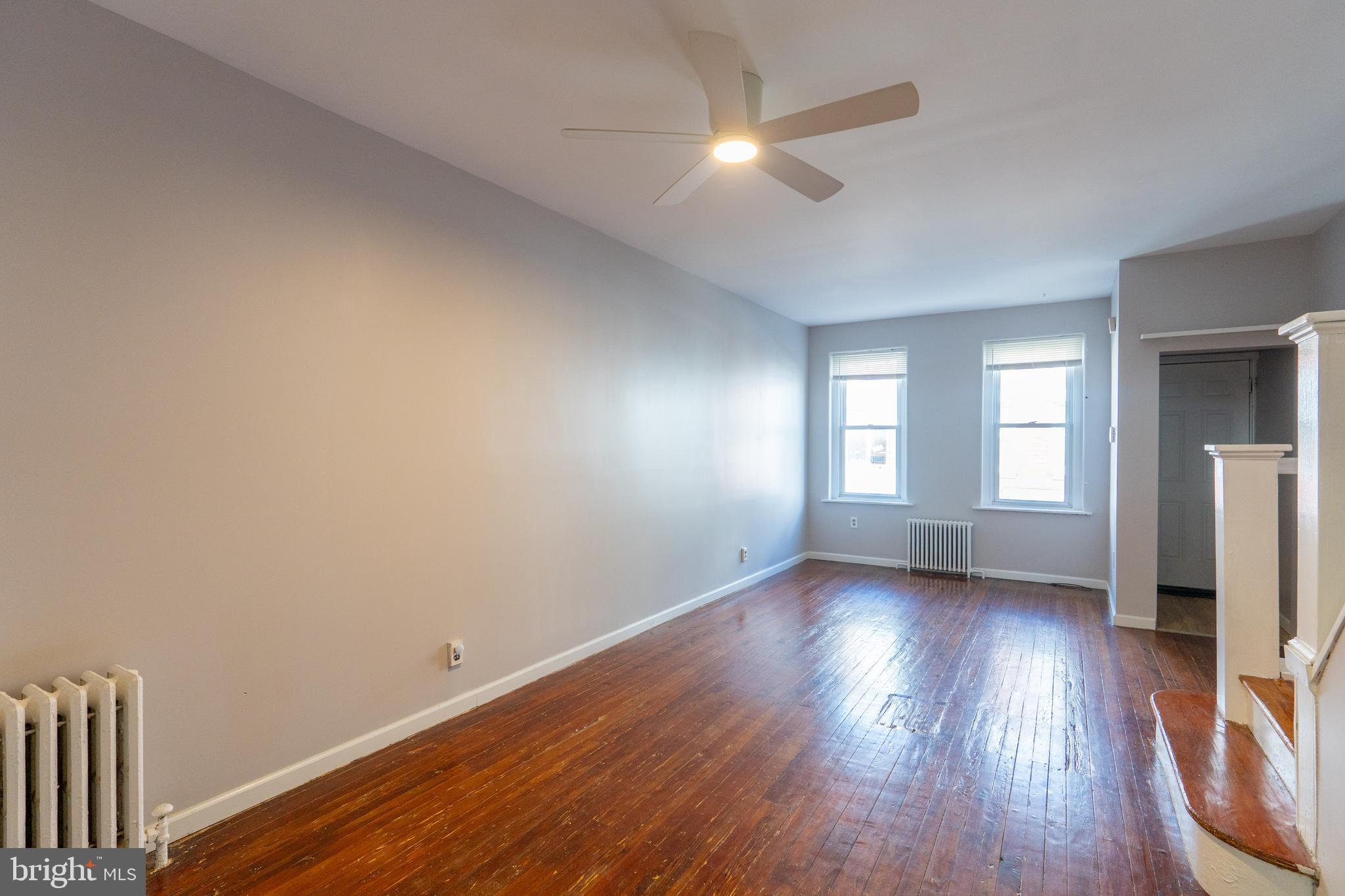 1826 McClellan Street Philadelphia, PA 19145 - Photo 5 of 22 an empty room with wooden floor and windows