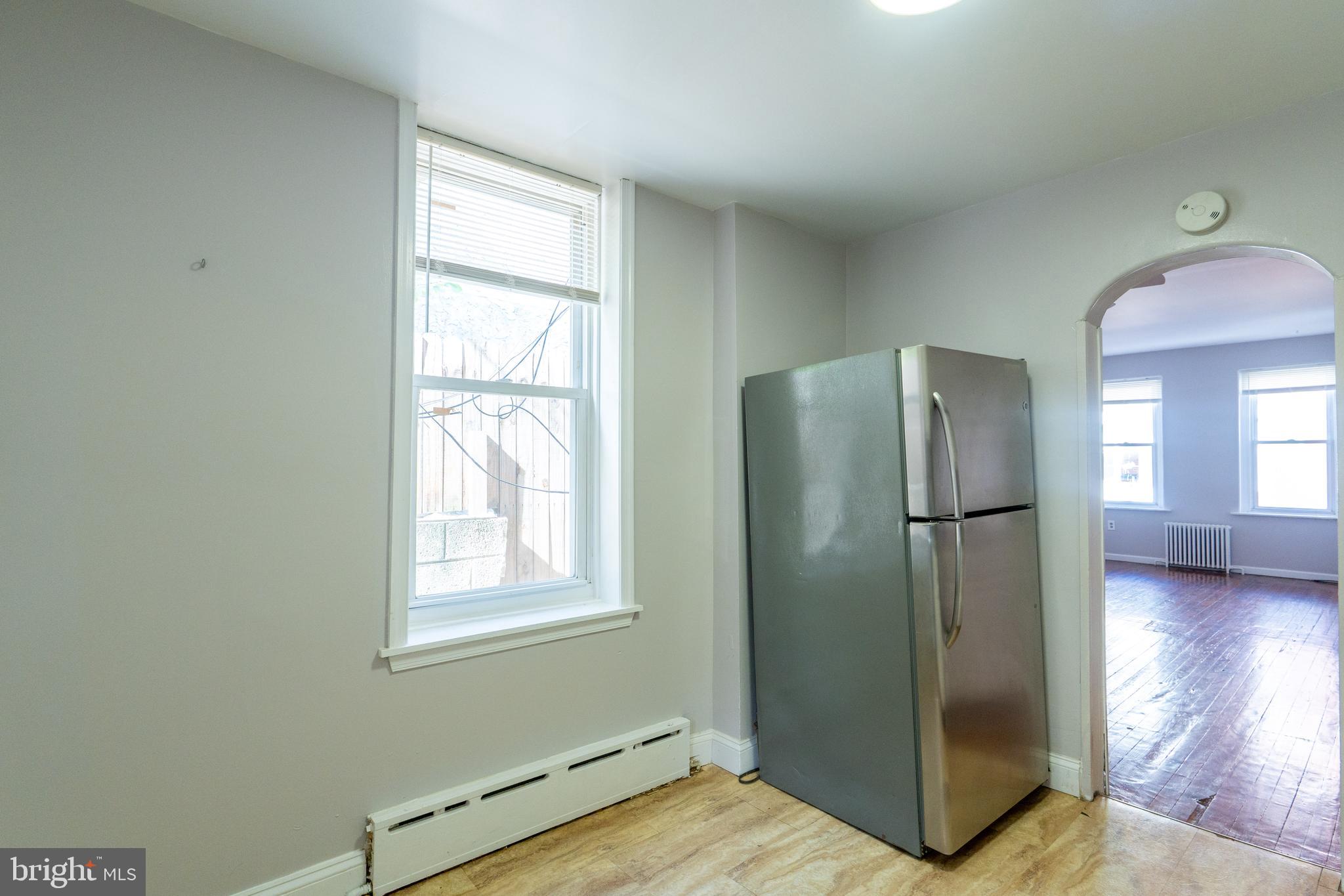1826 McClellan Street Philadelphia, PA 19145 - Photo 8 of 22 a view of kitchen with stainless steel appliances wooden floor and window
