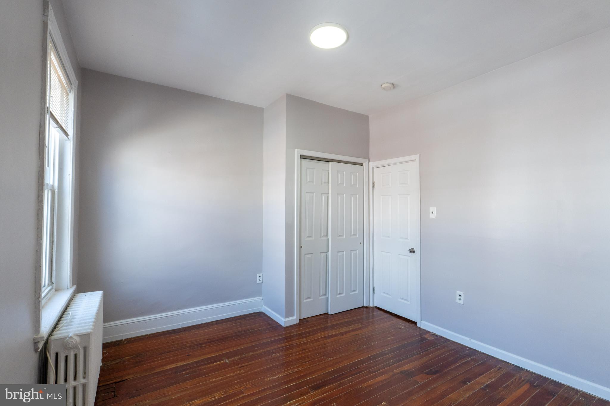 1826 McClellan Street Philadelphia, PA 19145 - Photo 10 of 22 a view of an empty room with wooden floor and a window