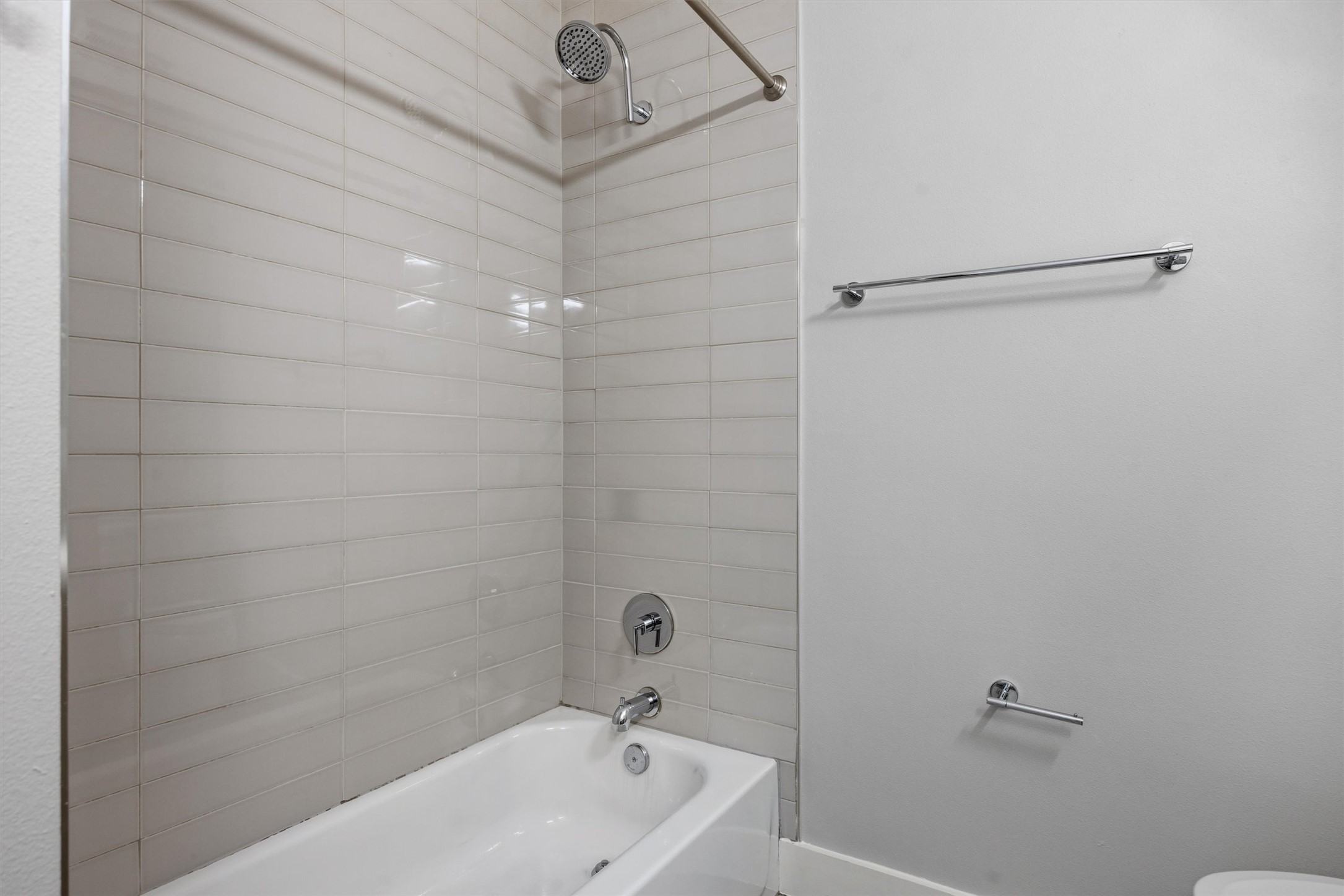 1210 Stobaugh Street, Unit B Austin, TX 78757 - Photo 8 of 40 A well-appointed bath with contemporary subway tile surround offers a fresh, clean aesthetic.