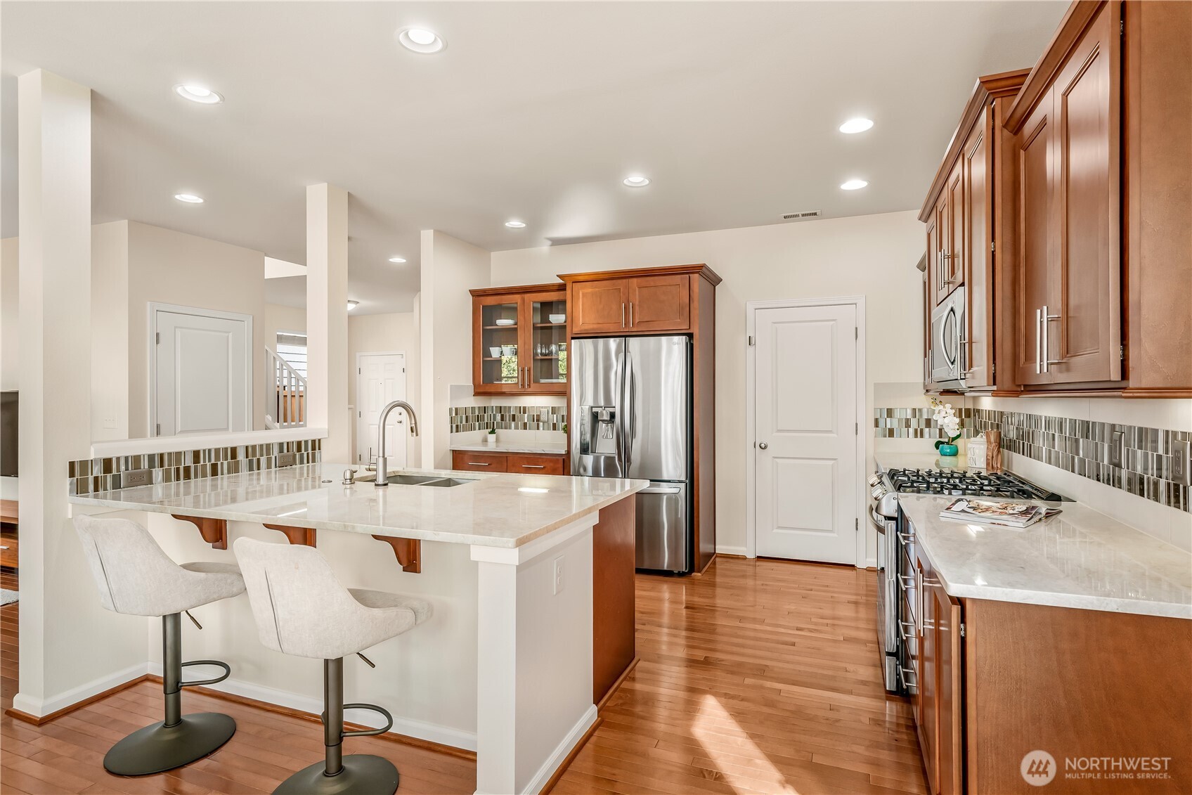 17712 39th Drive Southeast Bothell, WA 98012 - Photo 11 of 40 a kitchen with stainless steel appliances granite countertop a sink and a refrigerator