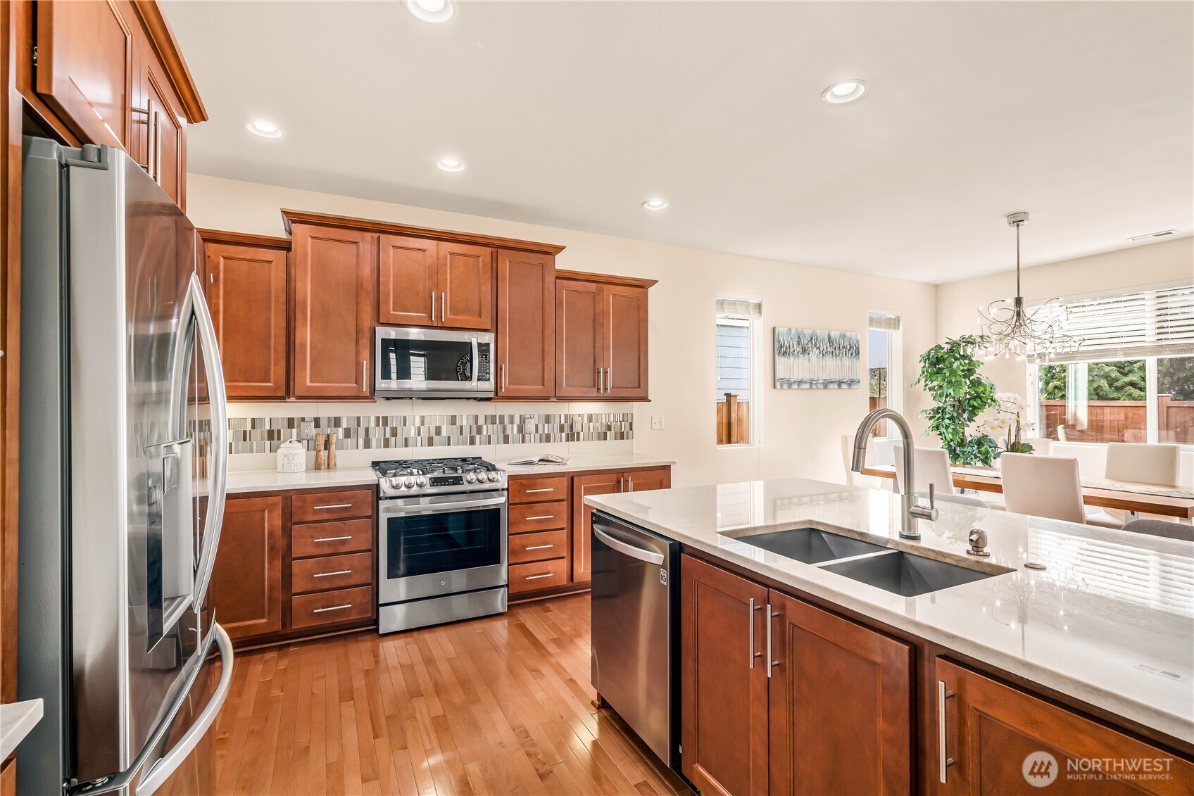 17712 39th Drive Southeast Bothell, WA 98012 - Photo 14 of 40 a kitchen with stainless steel appliances granite countertop a sink stove and refrigerator