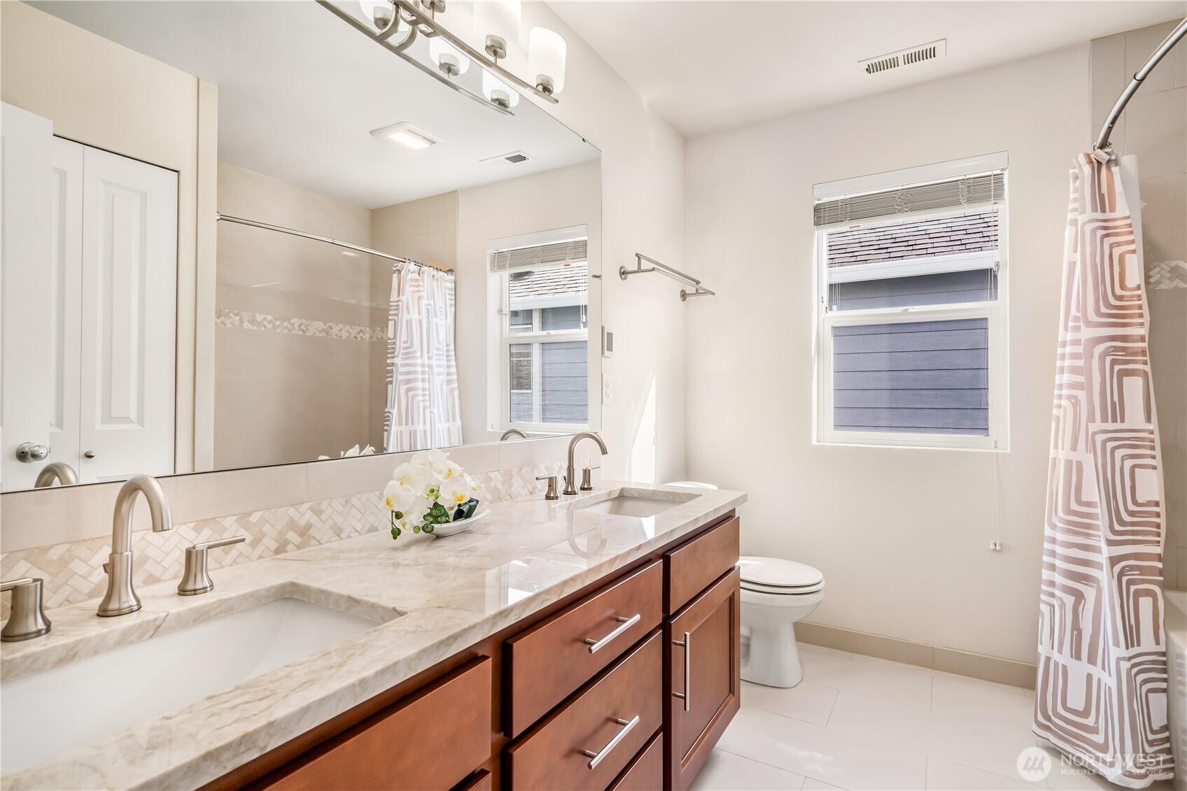 17712 39th Drive Southeast Bothell, WA 98012 - Photo 28 of 40 a bathroom with a granite countertop sink a toilet and a mirror