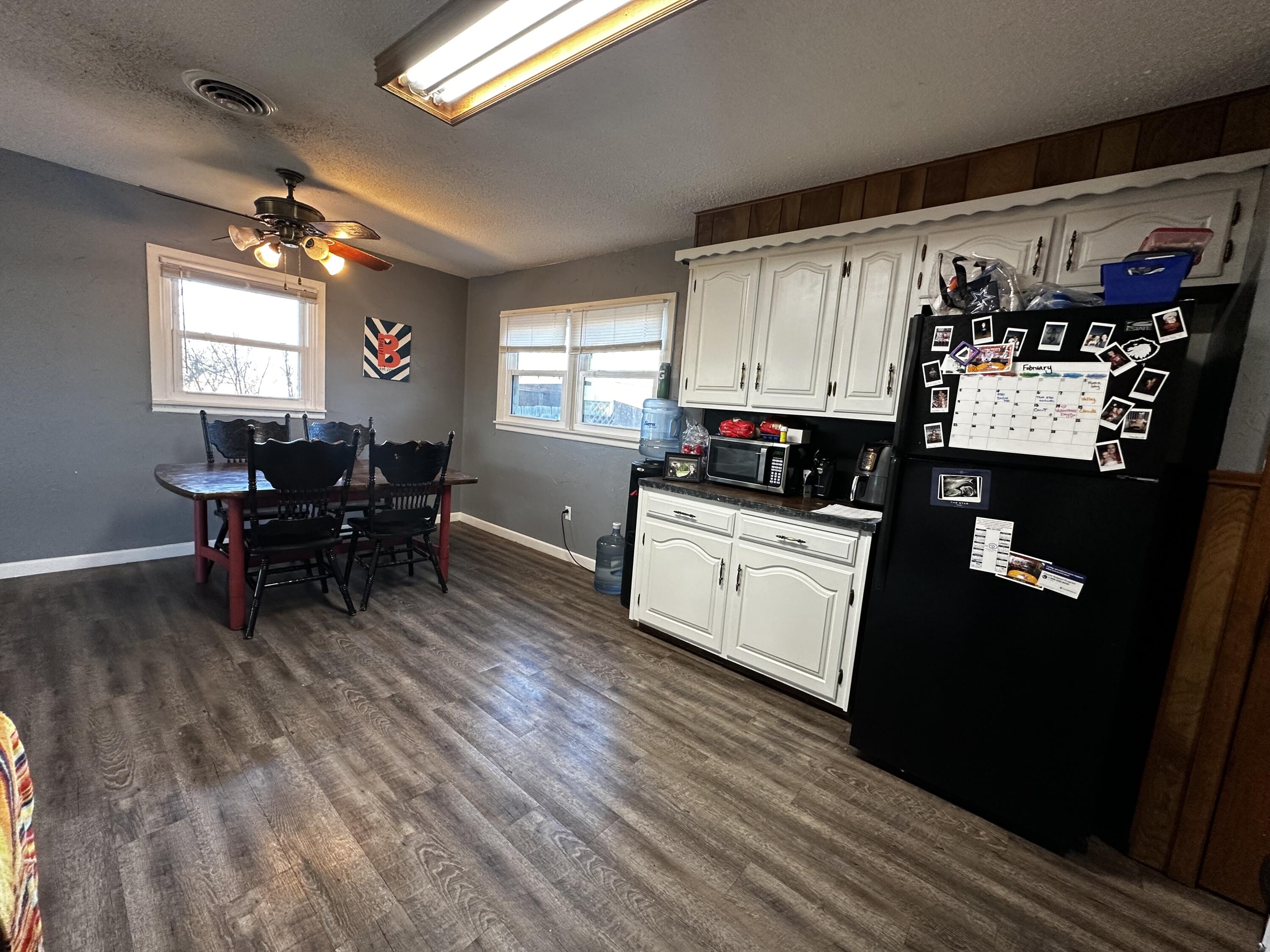 511 Childress Avenue Turkey, TX 79261 - Photo 4 of 20 a kitchen with granite countertop a sink cabinets and wooden floor