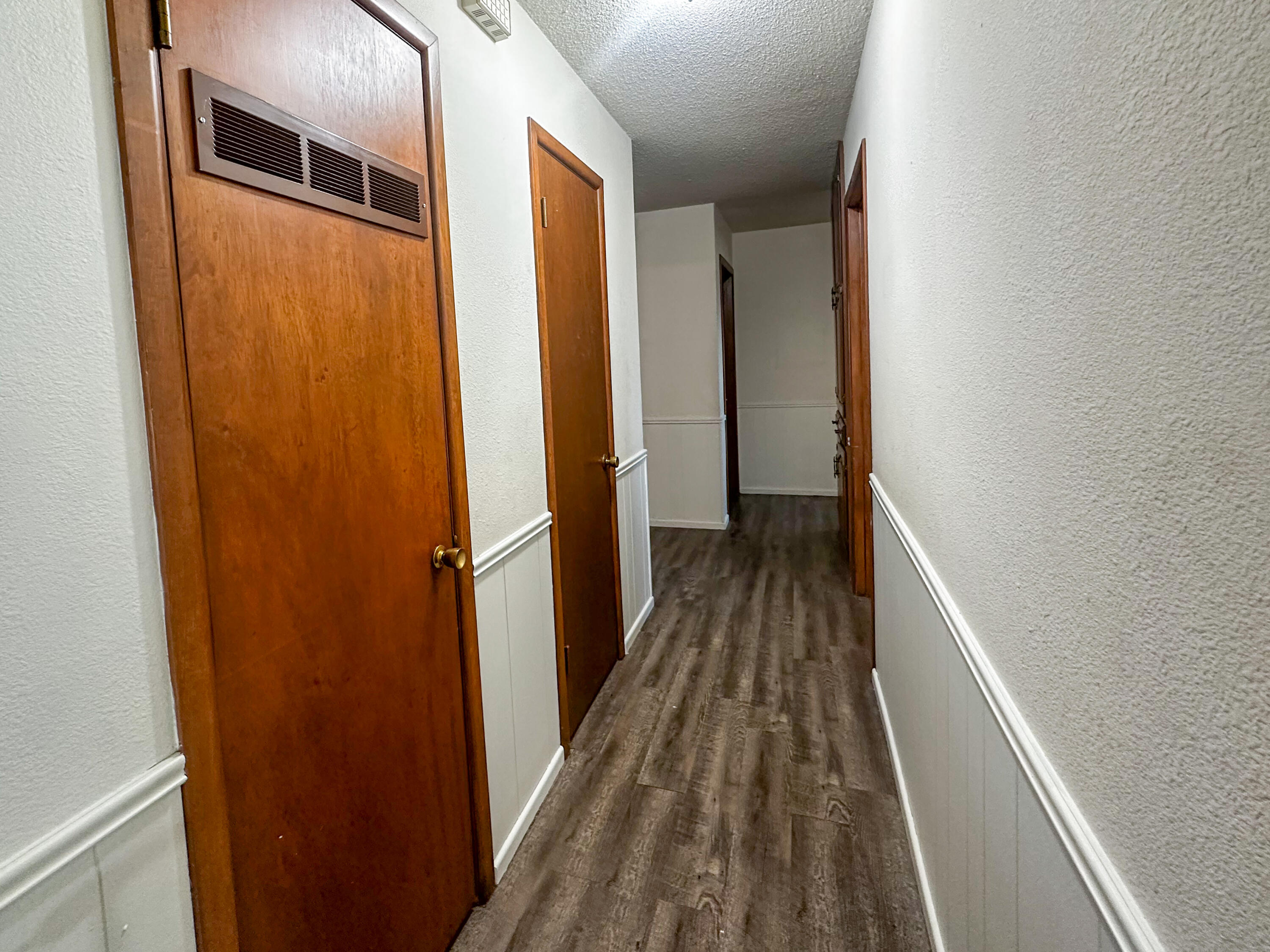 511 Childress Avenue Turkey, TX 79261 - Photo 8 of 20 a view of a hallway with wooden floor and staircase