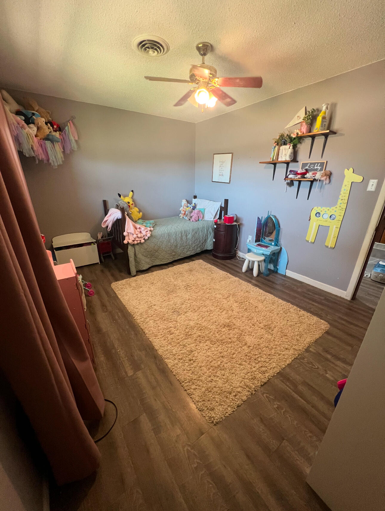 511 Childress Avenue Turkey, TX 79261 - Photo 10 of 20 a bed room with furniture and wooden floor