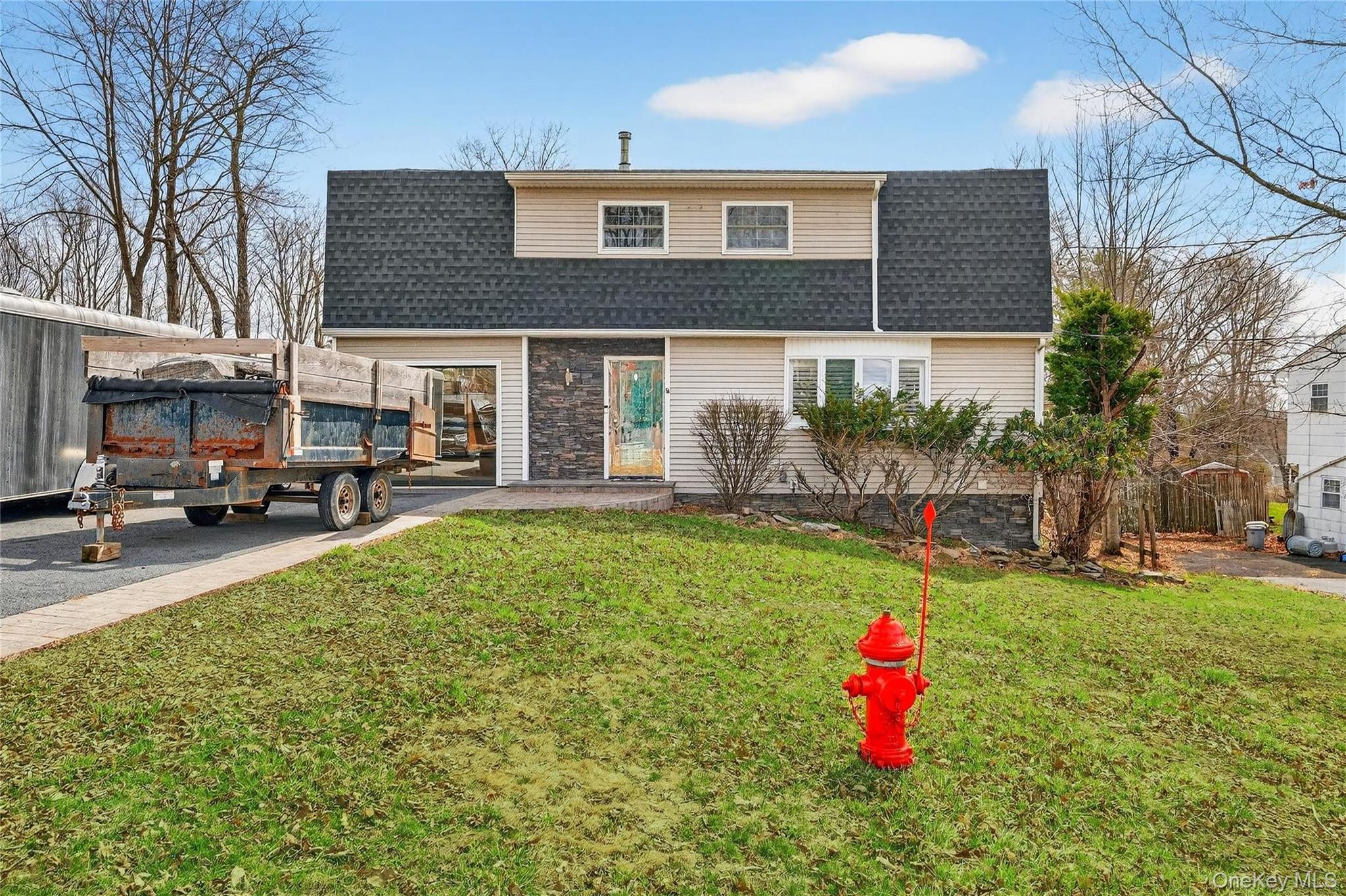 a house view with a sitting space and garden