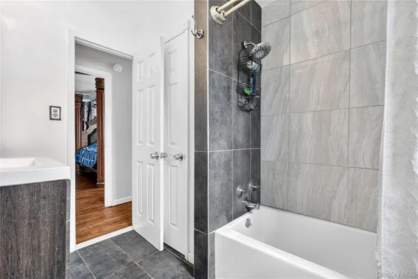 a bathroom with a bathtub and a shower