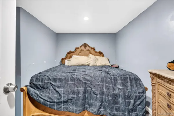 a bedroom with a bed and a mirror
