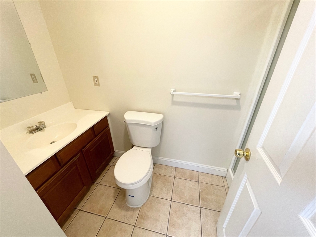 12 Pratt Street, Unit 105A Mansfield, MA 02048 - Photo 13 of 20 a white toilet sitting next to a bathroom sink