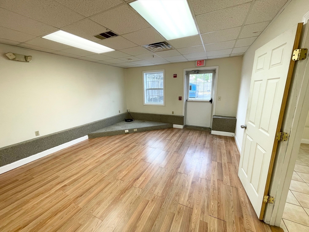 12 Pratt Street, Unit 105A Mansfield, MA 02048 - Photo 4 of 20 a view of empty room with wooden floor and fan