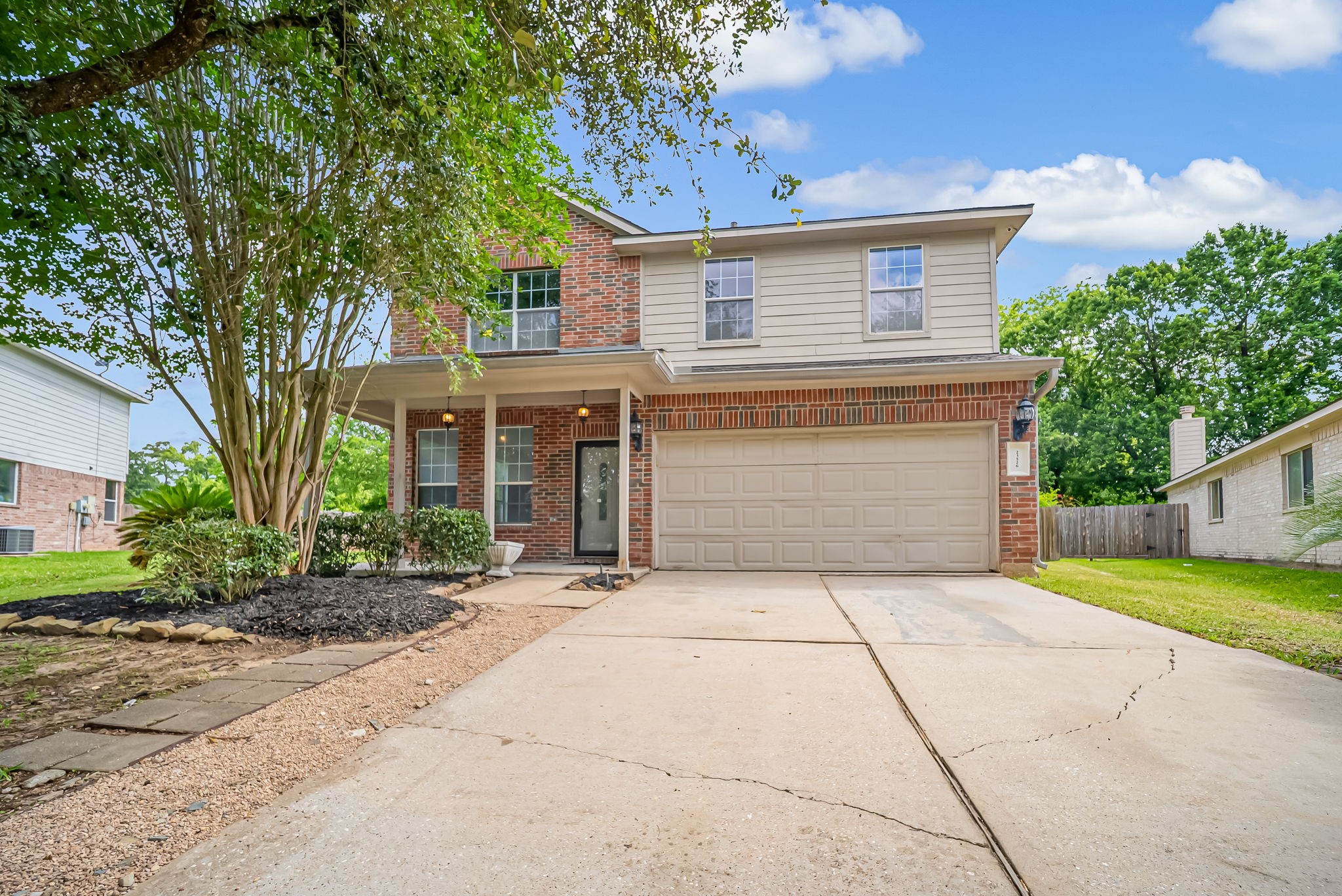 23526 Whispering Maple Drive Spring, TX 77373 - Photo 2 of 26 a front view of a house with a yard and garage