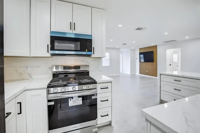 a kitchen with a stove and a microwave