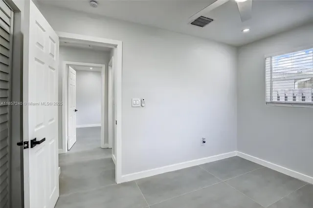 an empty room with windows and closet