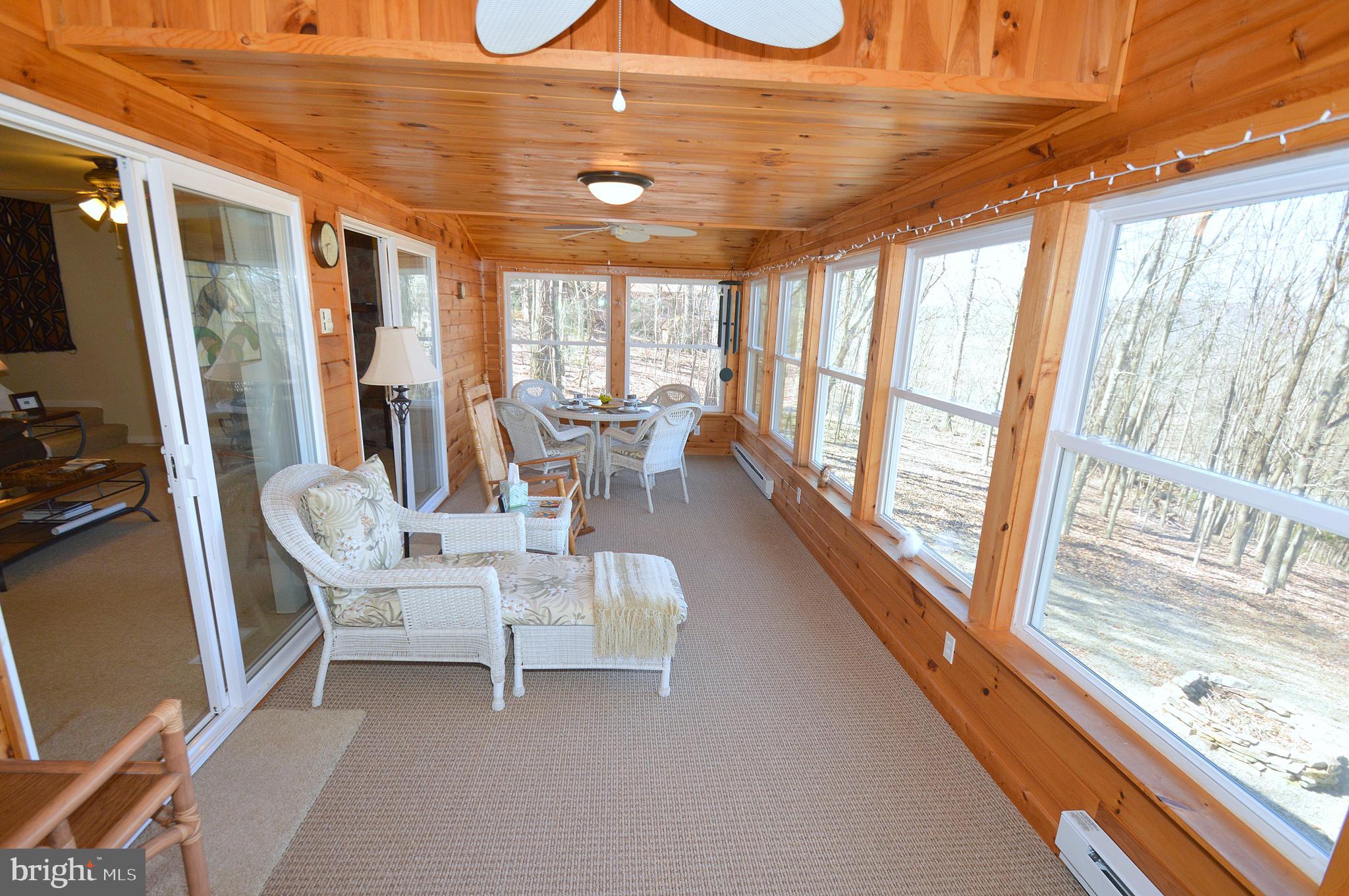 671 Razorback Ridge Road Great Cacapon, WV 25422 - Photo 17 of 35 Sun room.
