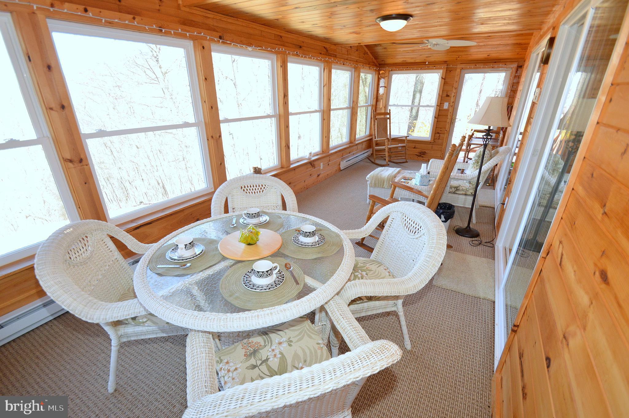 671 Razorback Ridge Road Great Cacapon, WV 25422 - Photo 18 of 35 Sun room.