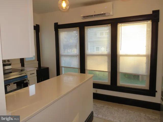 a bathroom with a sink toilet and window