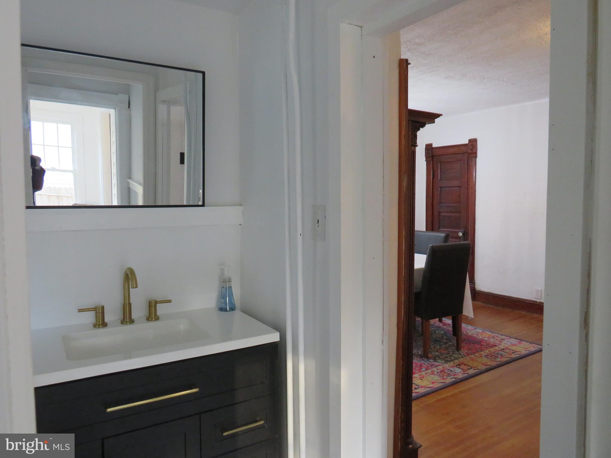 3372 Sackertown Road Crisfield, MD 21817 - Photo 18 of 29 a bathroom with a sink and a mirror