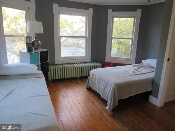 a bedroom with a bed and window