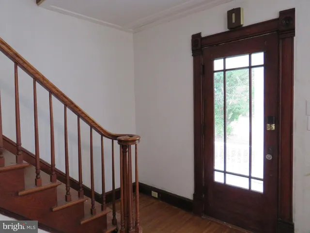 a view of entryway with wooden floor and stairs