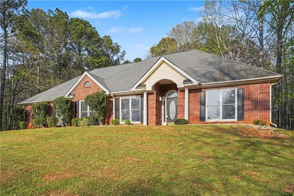 a front view of a house with a yard