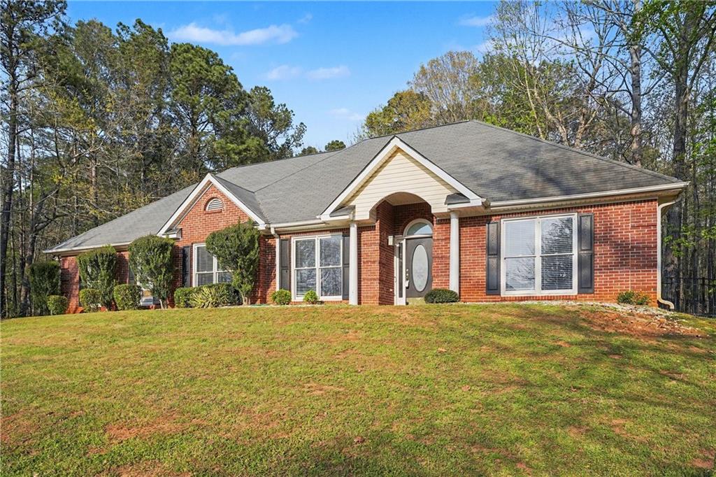 570 Morgan Court Hampton, GA 30228 - Photo 1 of 31 a front view of a house with a yard