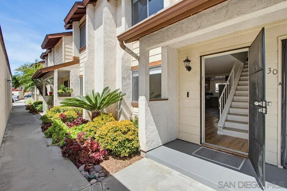5130 North River Road, Unit B Oceanside, CA 92057 - Photo 14 of 51 a front view of a house with a flower garden