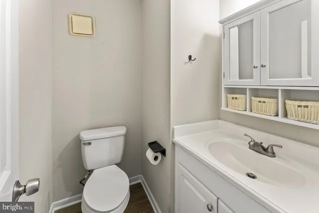 a white toilet sitting next to a bathroom sink