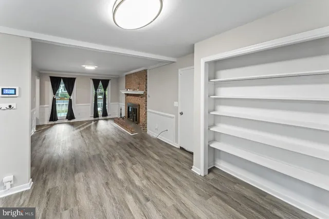 a view of an empty room and wooden floor