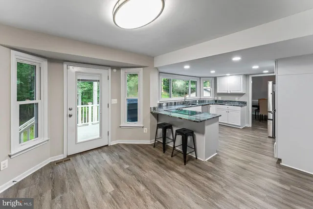 a kitchen with a table chairs and a refrigerator