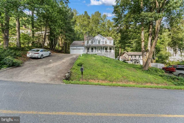 a view of a city street and parked cars