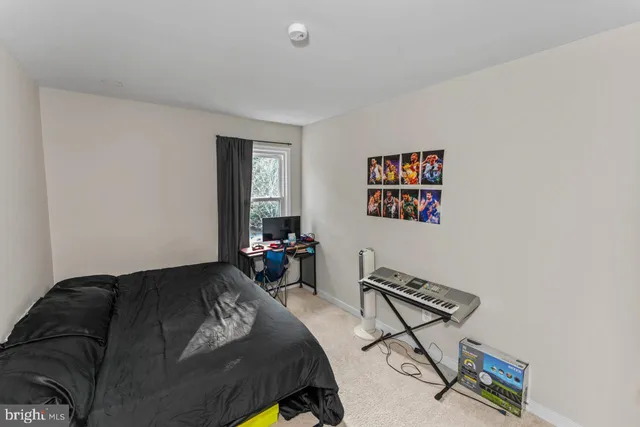 a bedroom with a bed and a dresser