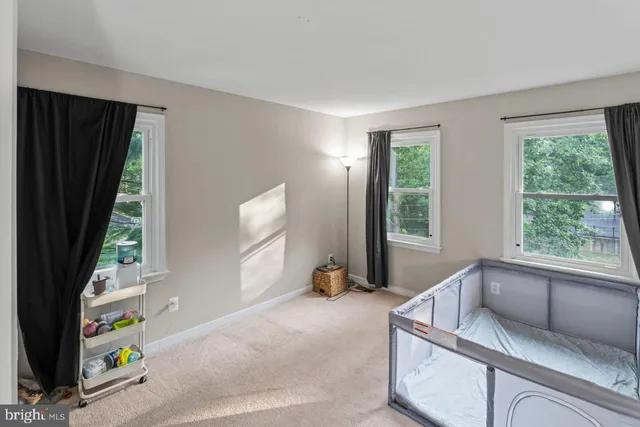 a hallway with a bed and a window