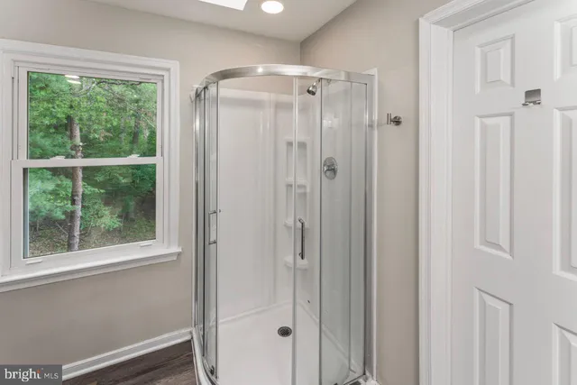 a bathroom with a glass shower door