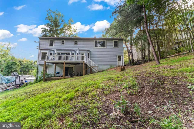 a view of a house with yard and a garden