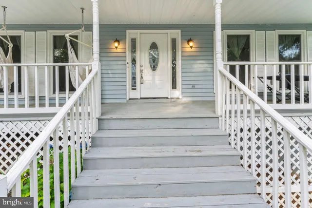 a view of entryway with wooden floor and a front door