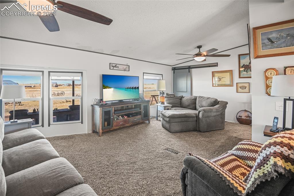 33440 Highway 94 Yoder, CO 80864 - Photo 17 of 30 a living room with furniture and a flat screen tv