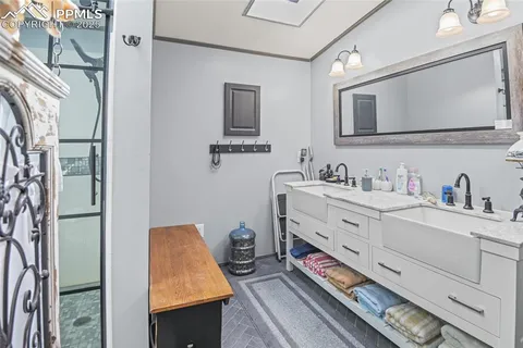 a bathroom with a sink vanity mirror and toilet
