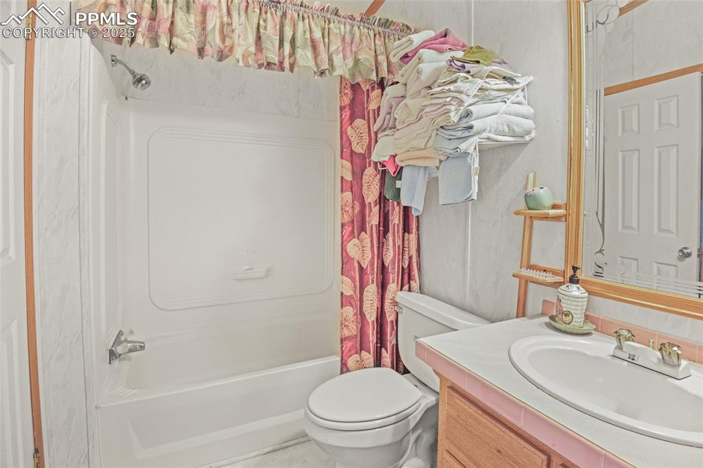 33440 Highway 94 Yoder, CO 80864 - Photo 22 of 30 a bathroom with a sink vanity mirror and toilet