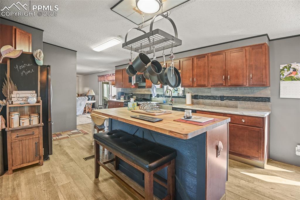33440 Highway 94 Yoder, CO 80864 - Photo 23 of 30 a kitchen with stainless steel appliances a stove a refrigerator and a sink