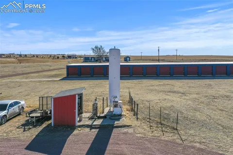 a view of a house with wooden fence
