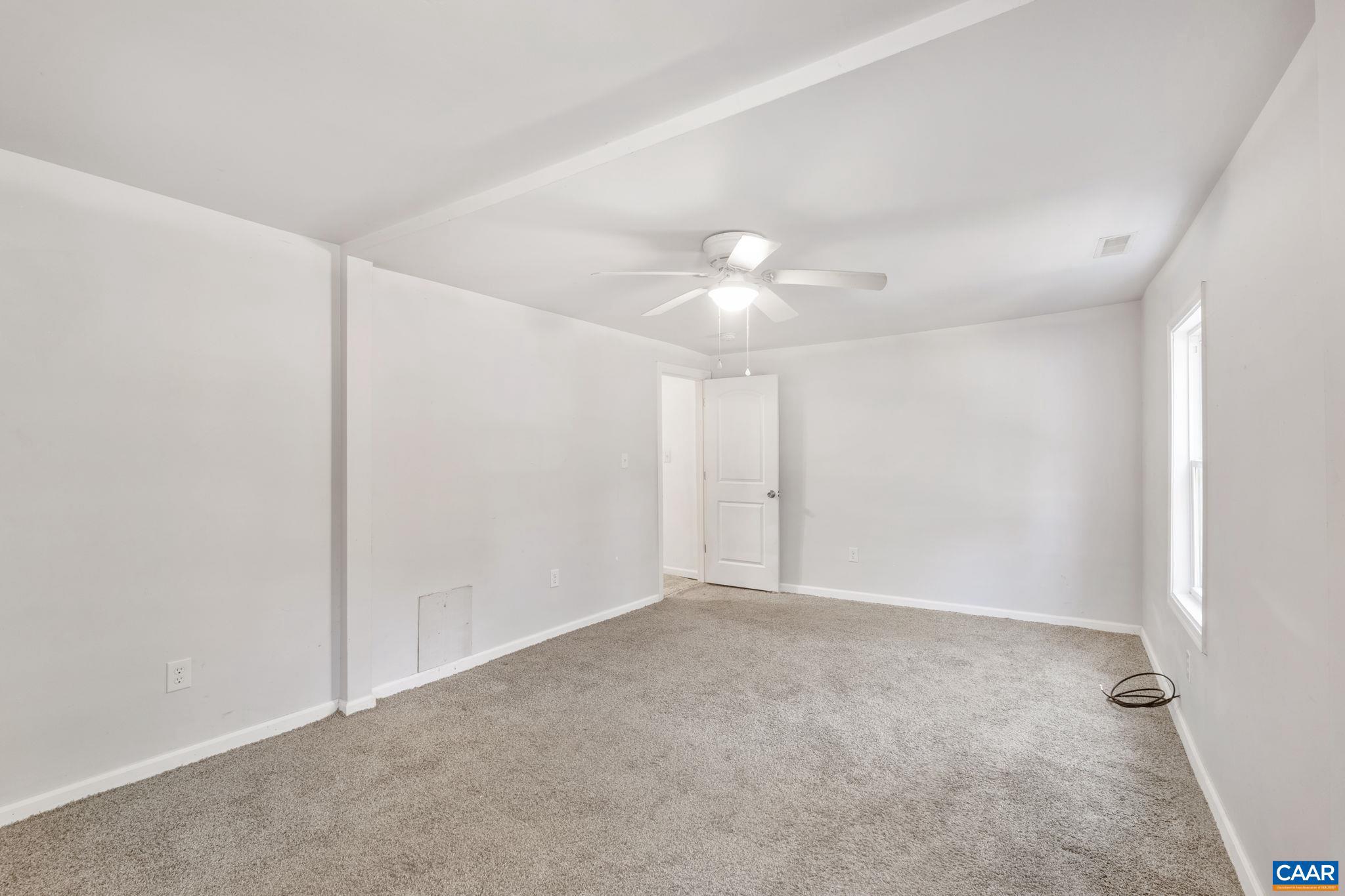 874 James River Road Scottsville, VA 24590 - Photo 20 of 43 a view of an empty room with a chandelier fan