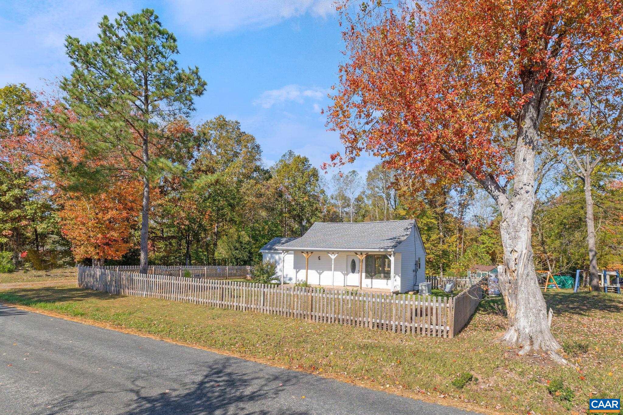874 James River Road Scottsville, VA 24590 - Photo 31 of 43 a view of a house with pool and trees in the background