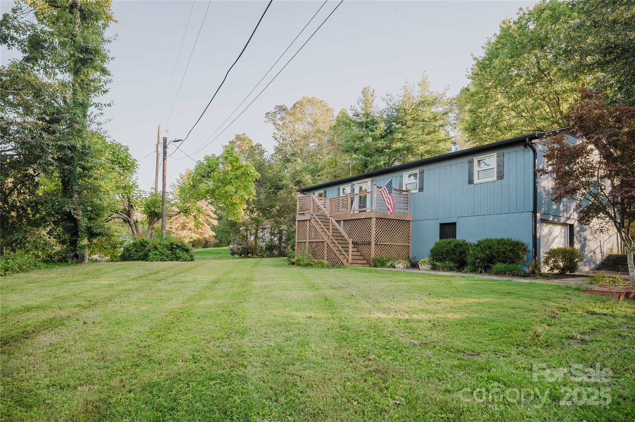 20 Ridgeway Drive Flat Rock, NC 28731 - Photo 6 of 47 a house that is sitting in the grass with tress in the background
