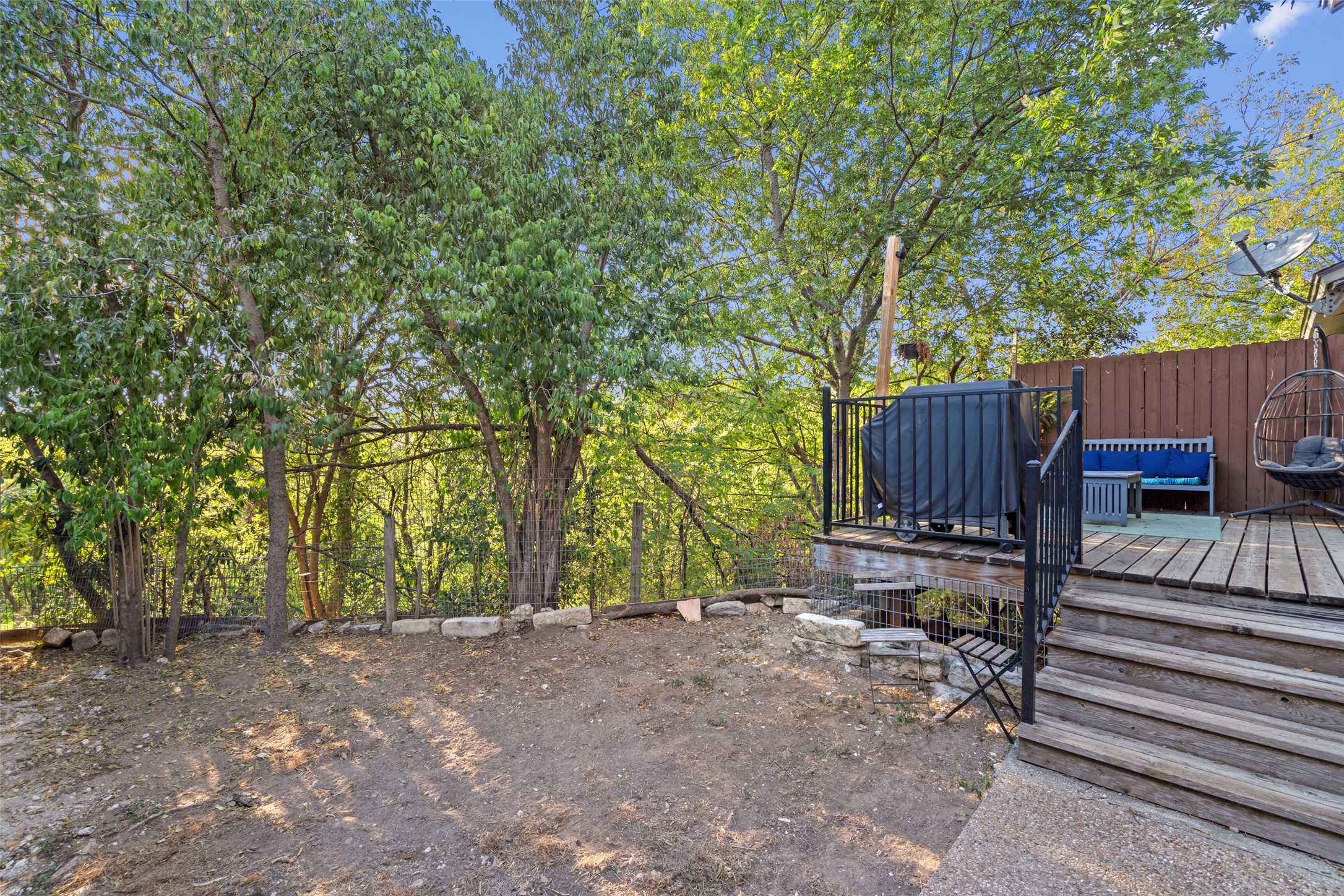 6492 Hart Lane Austin, TX 78731 - Photo 18 of 22 a view of a backyard with wooden fence and a large tree